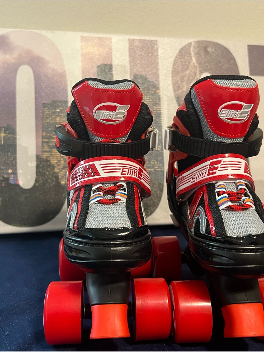 Eliiti adjustable kids' quad roller skates in red, black, and grey